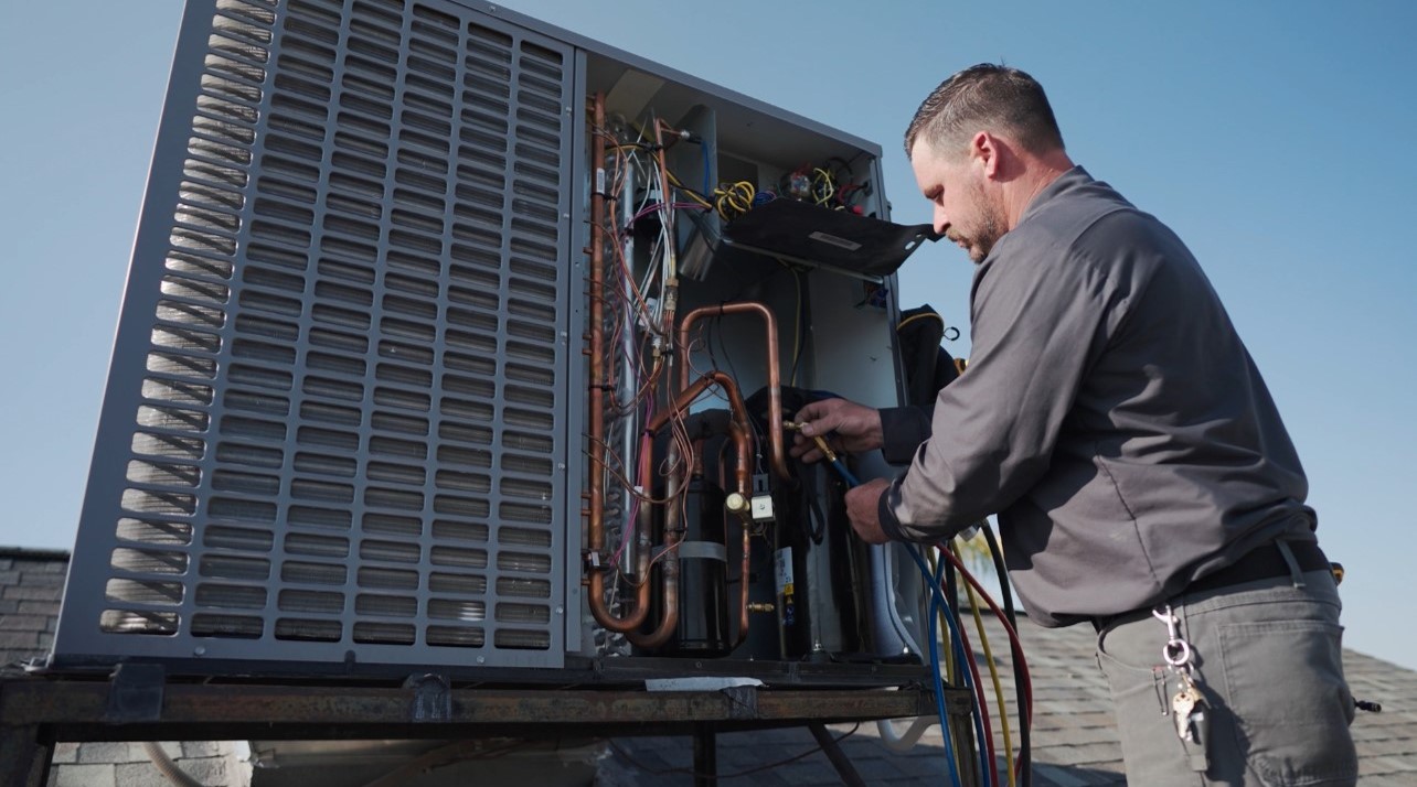 Technician testing an AC unit during a Fountain Hills service call