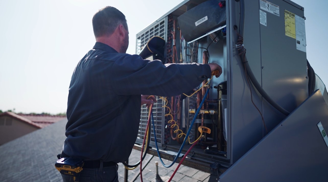Sonoran Sun technician repairing an air conditioner at a Fountain Hills home