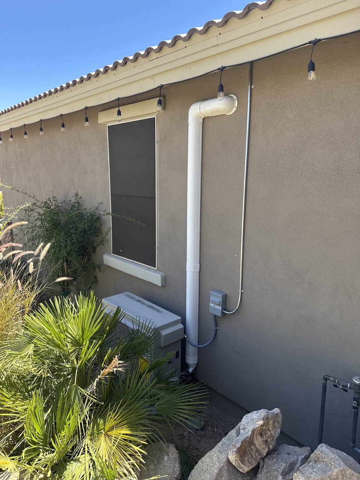 Ductless mini-split outdoor unit installed along the side of an East Valley home by Sonoran Sun Heating & Cooling