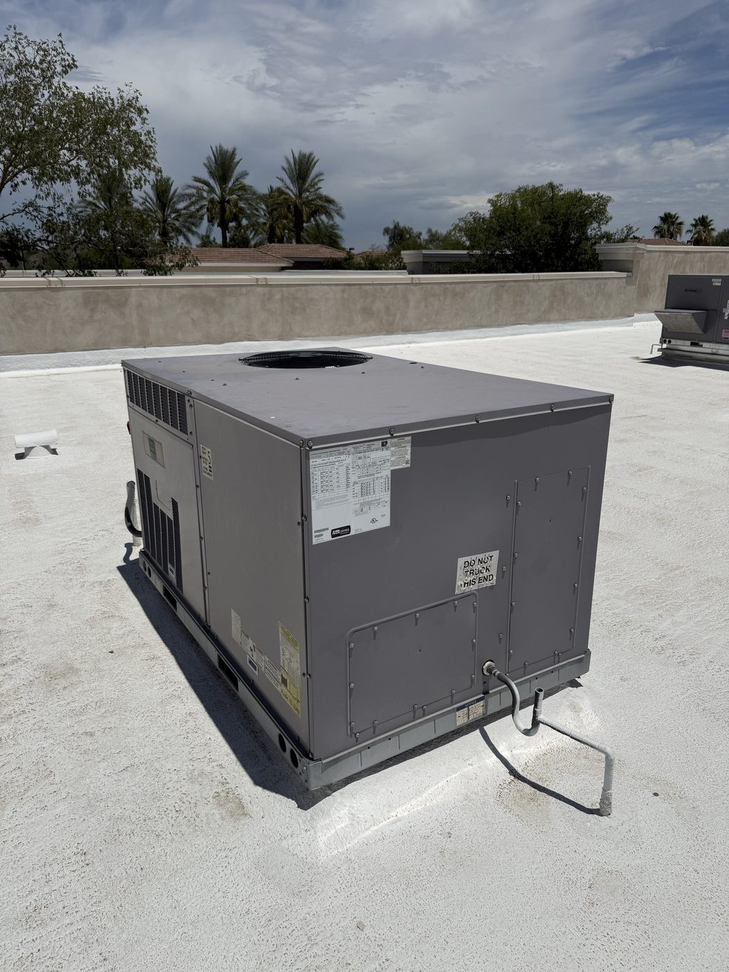 A newly installed rooftop package unit on a coated flat roof in Tempe