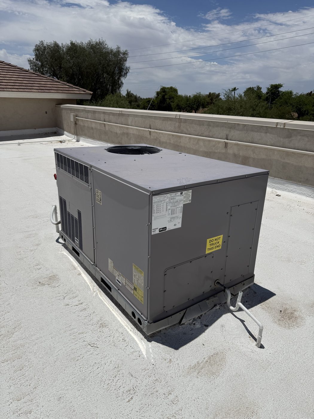 Rooftop package unit set and connected on a coated flat roof