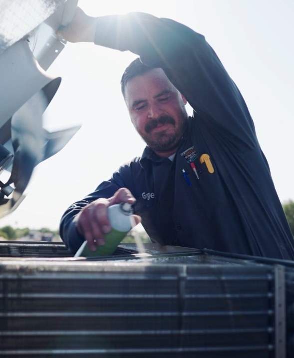 Gage, who leads the Sonoran Sun technical team, at work on a service call in the East Valley